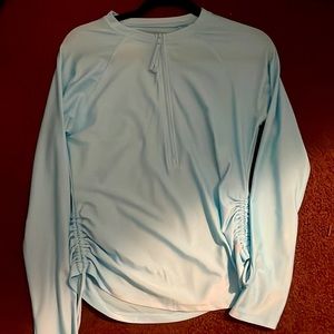 Light blue athletic shirt.